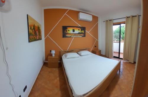 a bedroom with a white bed in a room at Palm Beach Resort in Boca Chica