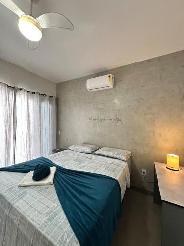 a bedroom with two beds and a air conditioner on the wall at Casa 2min do Centro & Piscina in Bonito
