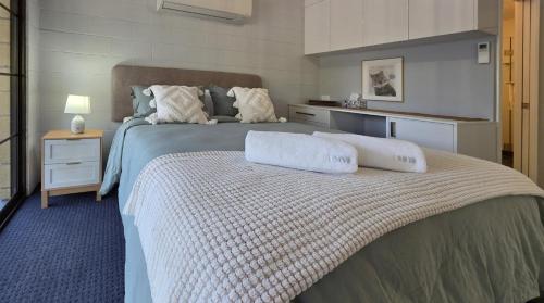 a bedroom with a bed with two pillows on it at Chandelle Park Farm Stay in Exeter