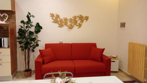 a red couch sitting in a living room at Palmieri Cozy Stay in Monopoli