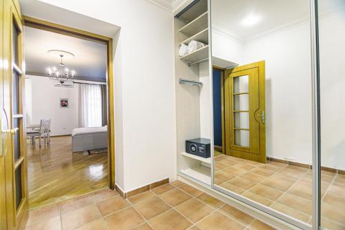 a hallway with a mirror and a dining room at Art Club in Baku