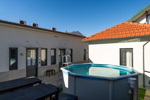 a swimming pool in the backyard of a house at Authentic Studio with Terrace by HostWise in Porto