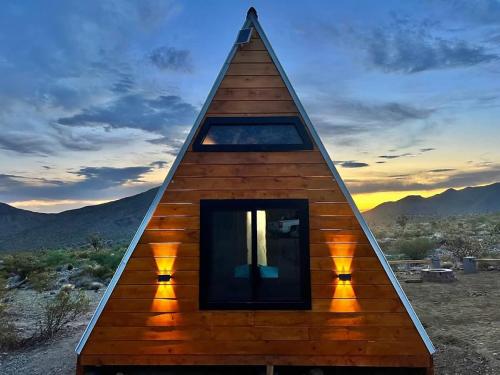 a triangular house with a window in the desert at Star Gazer #3 Glamping in Meadview