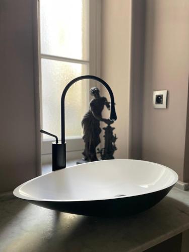 a bath tub sitting on a counter with a faucet at Chambre Gounod in Nice