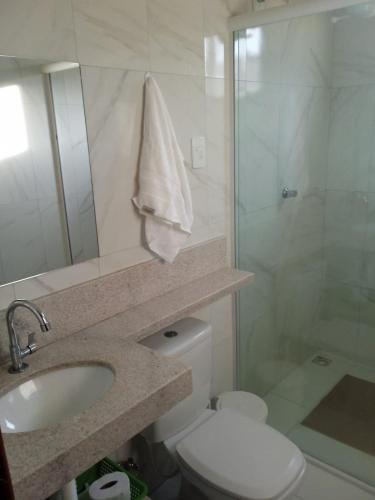 a bathroom with a toilet and a sink and a shower at Casa do Descanso in Triunfo