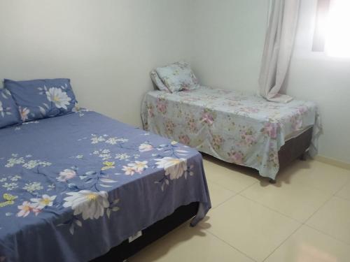 a bedroom with a bed and a chair in a room at Casa do Descanso in Triunfo