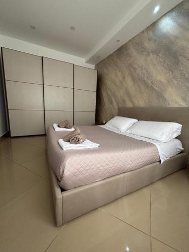 a bedroom with a large bed with towels on it at Casa vacanza Helios in Leonforte
