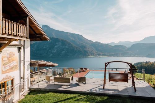 a house with a view of a lake and mountains at Mondseeblick Apartment KG in Innerschwand