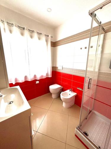 a bathroom with a toilet and a sink and a shower at Casa vacanza Helios in Leonforte