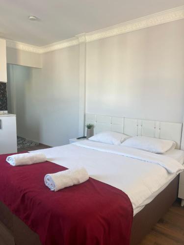 a large white bed with two towels on it at Balat Life Suites in Istanbul