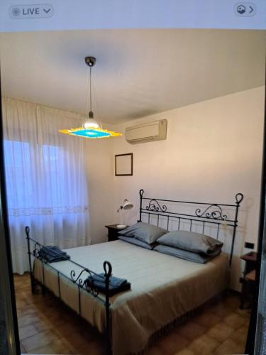a bedroom with a bed and a chandelier at appartamento yuliet in Città di Castello