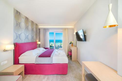 a hotel room with a large bed and a window at Iliorama Luxury Apartments in Skala Potamias