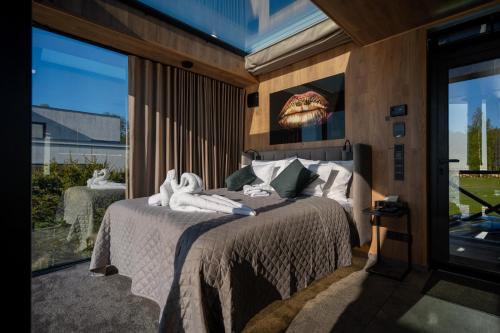 a bedroom with a bed with towels on it at Luxury Resort Reiu in Reiu