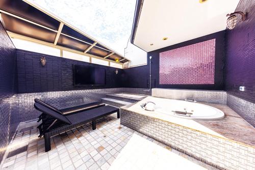 a large bathroom with a tub and a sink at Hotel Shiro No Kyuden in Ibaraki