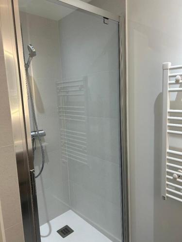 a shower with a glass door in a bathroom at Les Granges Dorées in Châtillon
