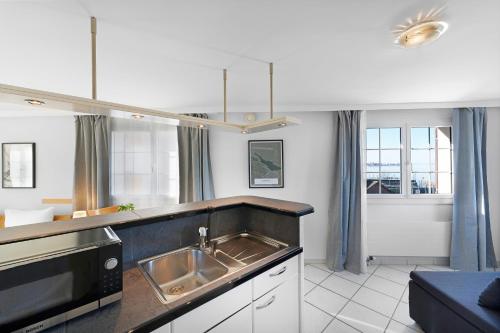 a kitchen with a sink and a microwave at Hotel Schiff in Horn