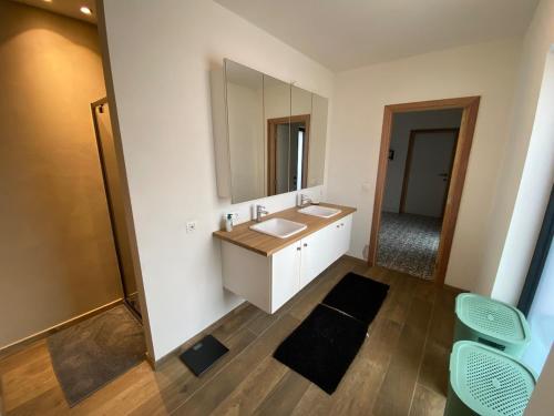 a bathroom with a sink and a mirror at Spacious house specially for workers and expats in Maldegem
