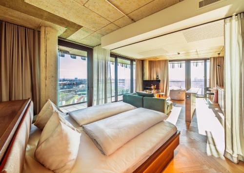 a bedroom with a bed and a large window at The Zipper Hotel und Apartments in Düsseldorf