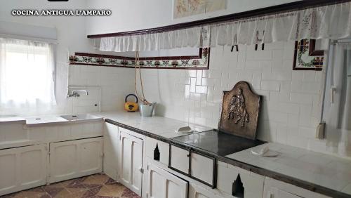 a kitchen with a sink and a counter top at Casa rural L´Amparo -3 espigas- Categoría superior-15 personas in Navarrete del Río