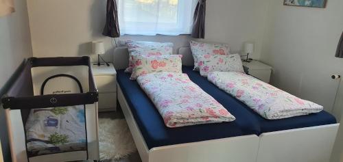 a bed in a room with two pillows on it at Ferienwohnung Christel und Andreas in Sulzfeld