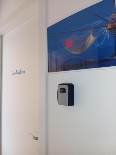 a refrigerator with a tv on the wall at Dimore Fronte Mare affittacamere in Casalbordino