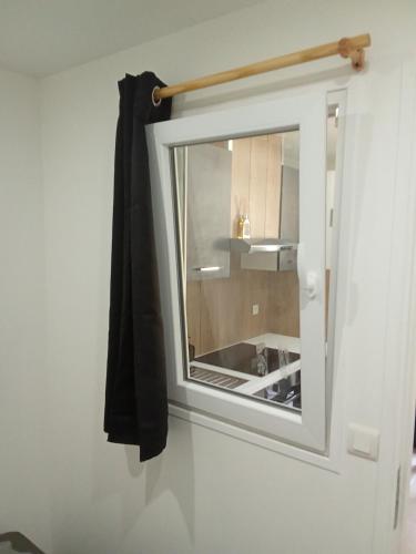 a window in a white room with a kitchen at EVASION LOUE #5 x2 people "La POTERIE" in Lods