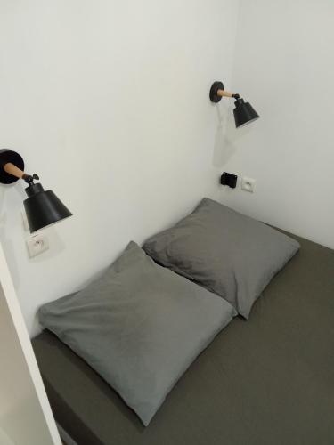 a bed with two lamps and two pillows in a room at EVASION LOUE #5 x2 people "La POTERIE" in Lods