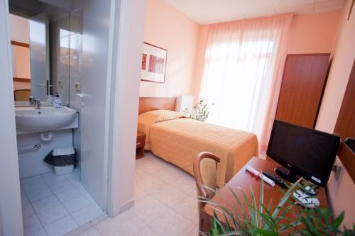 a bathroom with a bed and a sink in a room at Casa Per Ferie Canobi 18 in Rome