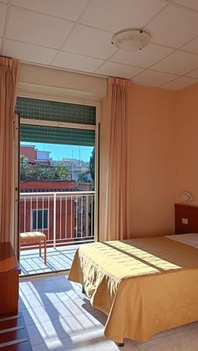 a bedroom with a bed and a large window at Casa Per Ferie Canobi 18 in Rome