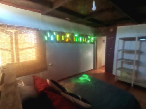 a room with a couch and green lights on the wall at Refugio del Pirata Algarrobo in San Antonio