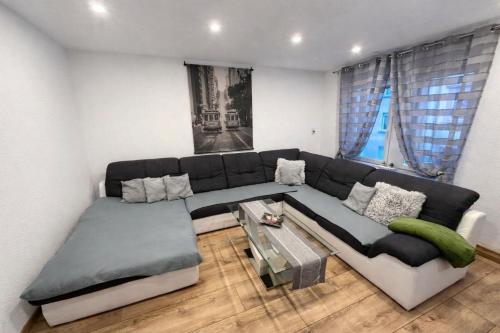 a living room with a couch and a table at Ferienwohnung AyNa 2, direkt an der Schweizer Grenze in Bad Säckingen