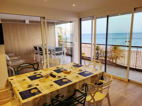 a dining room with a table and a view of the ocean at Levante Frontline Luxury Duplex 5 Bedrooms in Benidorm
