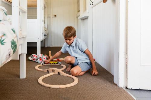 a young boy playing with a toy on the floor at Croftby Hills - Scenic Rim in Croftby