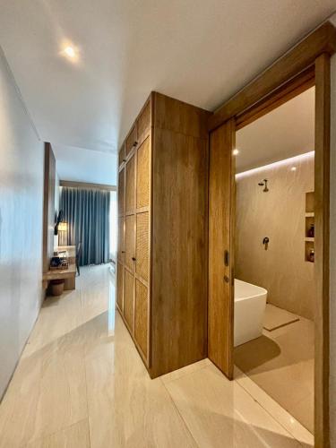 a bathroom with a tub and a toilet and a sink at Truntum Boutique Mandalika in Kuta Lombok