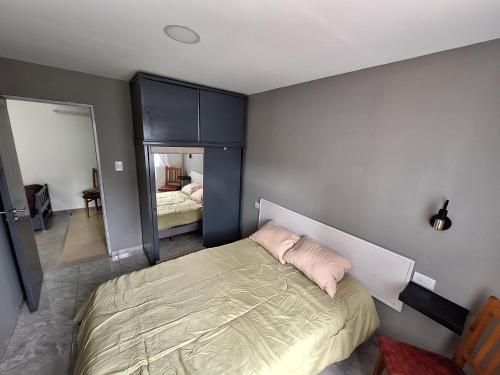 a bedroom with a bed with a pillow on it at departamentos 4 personas,N3 Aire acondicionado Wifi TvCable Parrilla in Santa Teresita