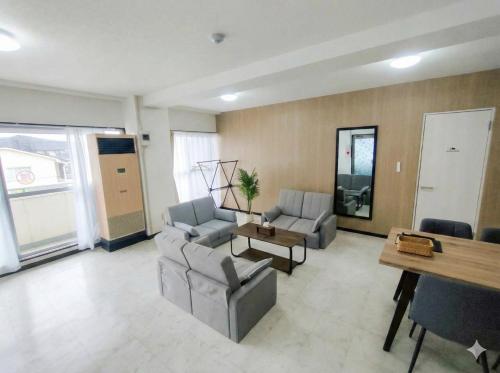 a living room with two couches and a table at -Ina Stay Central Hotel-8名宿泊可 伊那市駅徒歩5分 駐車場無料 a sleep8-a 5minute walk from the station-Free parking in Ina