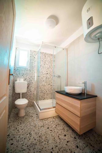a bathroom with a shower and a toilet and a sink at Marepromo Žirje in Žirje