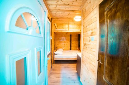 a small room with a bed and a door at Marepromo Žirje in Žirje