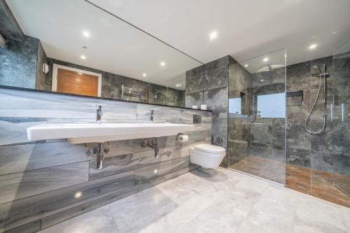 a bathroom with a sink and a shower and a toilet at Parklands in Penrith