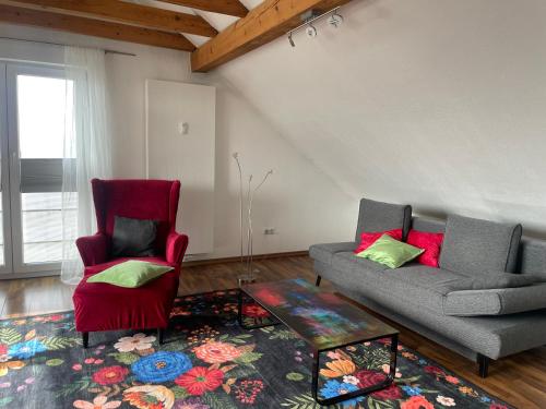 a living room with a couch and a chair at Fewo extraschön - Dachgeschoss in Lindau