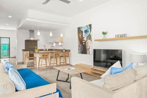 a living room with a couch and a table at Ama Villas - Luxury Private Villas in Mont-Choisy Beach in Mont Choisy