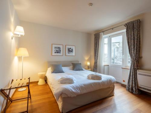 a bedroom with a large bed and a window at Gîte du Vieux Moulin in Rochefort
