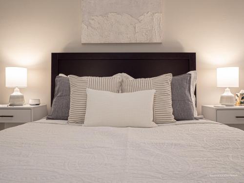 a bedroom with a white bed with two lamps at The Battery Hideaway in Marietta