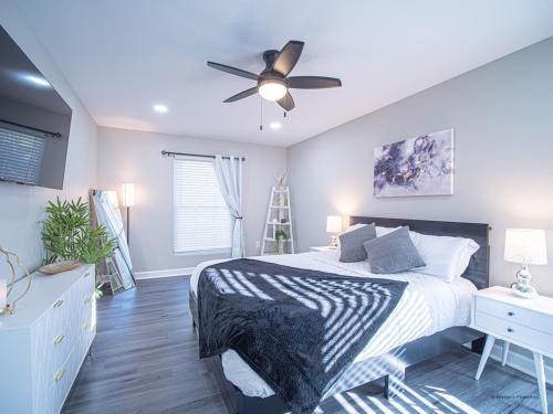 a bedroom with a bed and a ceiling fan at The Franklin in Marietta in Marietta