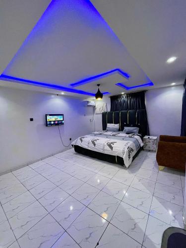 a bedroom with a bed with blue lights on the ceiling at Bellconpet Apartment in Sagisa