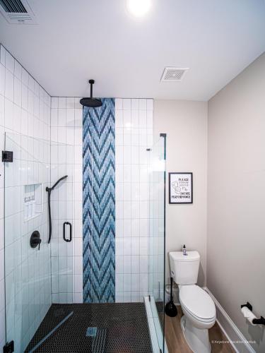 a bathroom with a toilet and a glass shower at The Maison at Marietta Square in Marietta