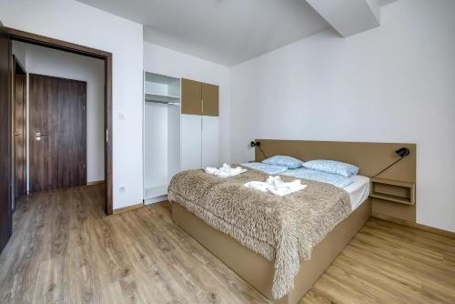 a bedroom with a bed with two towels on it at Villa Oliver 2 Budapest in Budapest