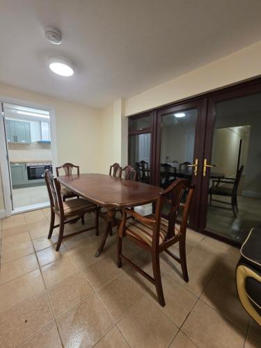 a dining room with a wooden table and chairs at ELI STAY Ensuite rooms in Ipswich