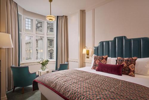 a hotel room with a bed and a window at The Bedford Hotel Belfast in Belfast
