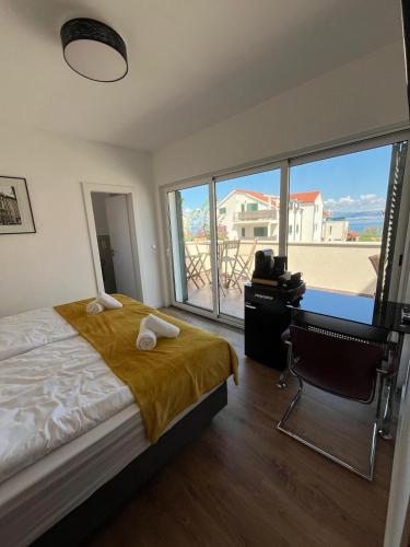 a bedroom with a bed and a desk and a window at BCM Weidinger in Mirce